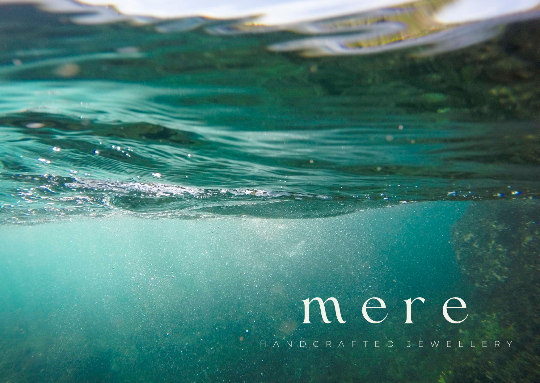 Underwater view with 'mere' handcrafted jewellery logo
